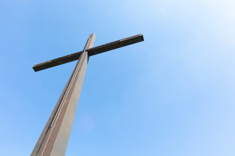 A big metal cross and a clear sky -the concept of religion